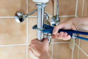 plumber repairing the bathroom plumbing in a miami home